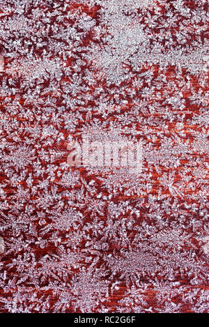 vertical beautiful festive background from a texture of patterns of white ice crystals on a wooden surface Stock Photo