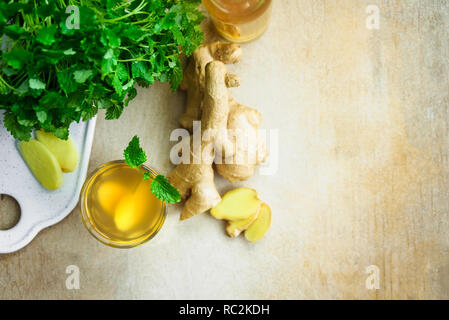 Glass with ginger detox water and ingredients near it. Wooden background. Top view. Copy space Stock Photo