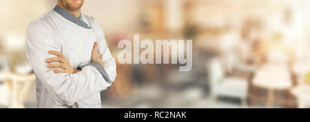 chef standing in restaurant with crossed arms. banner copy space Stock Photo