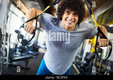 Sport, fitness, bodybuilding, lifestyle and people concept - man exercising in gym Stock Photo