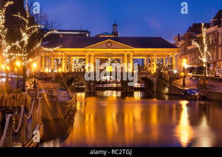 Leiden, The Netherlands, January 7, 2019: the Corn Exchange Bridge (Koornbrug) with its neo-classicist roof reflects in the water of the New Rhine dur Stock Photo