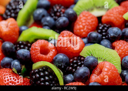 Rich harvest of various mix of fresh fruits, colorful fresh overhead berries assorted arrangement Stock Photo