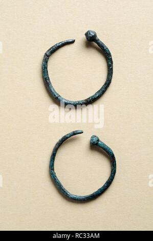 Two earrings circular bronze decorated with ball end . Diameter 2, 5 cm Thickness 0, 4 cm.( 1 st - 3 rd CE ) - Roman period, from the ' House of Hyppolytus '- Archaeological site of Complutum in Alcalá de Henares ( Madrid ). SPAIN. Stock Photo
