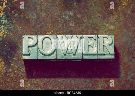 power word made from metallic letterpress on rusty metallic background Stock Photo