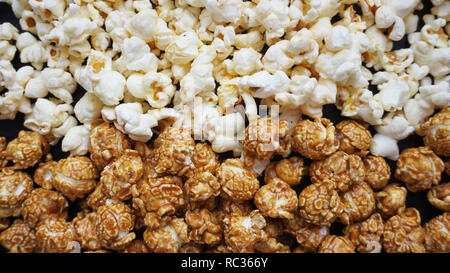 Assorted popcorn set. Sweet and salty popcorn on black background Stock Photo