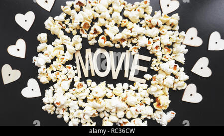 Popcorn on black background. Watching a movie with popcorn. Copy space Stock Photo