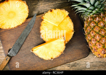 fresh pineapple sliced on wooden background Stock Photo