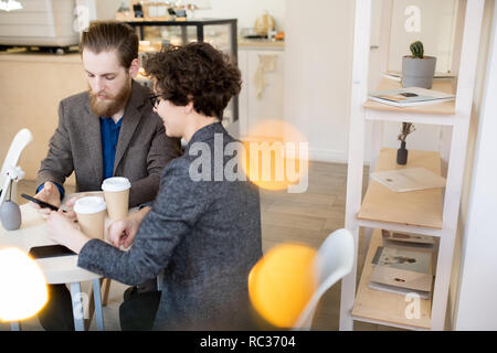 Young couple having coffee break in cafe Stock Photo