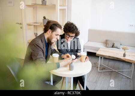Busy managers discussing project in cafe Stock Photo