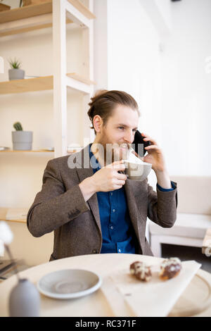 Hipster businessman drinking coffee in cafe Stock Photo