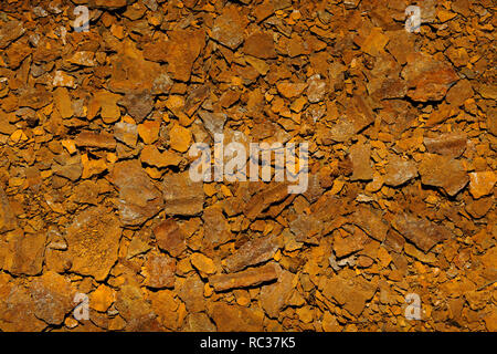 Flakes of dry rusted metal from corroded metal bucket. Stock Photo
