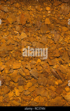 Flakes of dry rusted metal from corroded metal bucket. Stock Photo