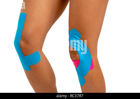 Knee treated with kinesio tex tape therapy. Injured woman knee with  tratament of kinesio tape Stock Photo