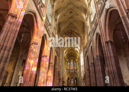 Prague St Vitus Cathedral nave and sanctuary coloured with light from the stained glass windows Prague Castle Prague Czech Replublic Europe Stock Photo