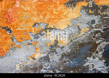 Orange color Half plastered wall with peeling paint with space for text Stock Photo