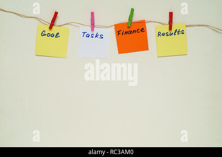 Words Goal, Tasks, Finance, Results on multicolored paper stickers with clothespins on a rope. Copy space Stock Photo