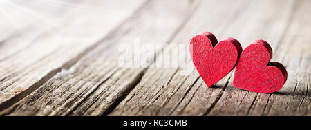 Two Wooden Hearts On Rustic Table With Sunlight Stock Photo