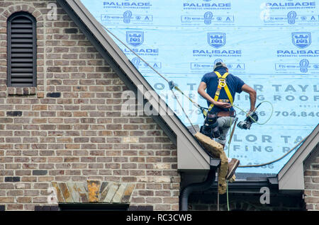 Roofing Contractors Replacing Damaged Roofs After a Hail Storm Stock Photo