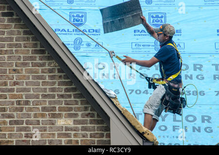 Roofing Contractors Replacing Damaged Roofs After a Hail Storm Stock Photo