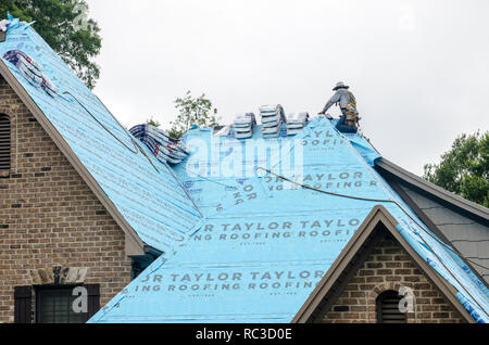 Roofing Contractors Replacing Damaged Roofs After a Hail Storm Stock Photo