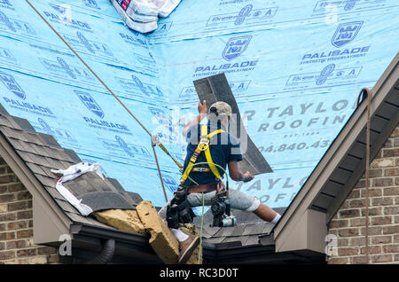 Roofing Contractors Replacing Damaged Roofs After a Hail Storm Stock Photo