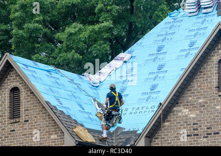 Roofing Contractors Replacing Damaged Roofs After a Hail Storm Stock Photo