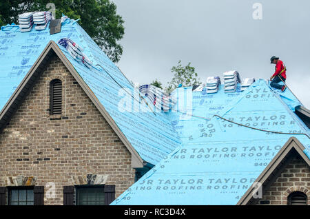 Roofing Contractors Replacing Damaged Roofs After a Hail Storm Stock Photo