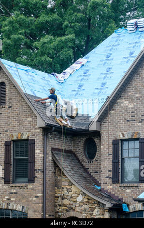 Roofing Contractors Replacing Damaged Roofs After a Hail Storm Stock Photo