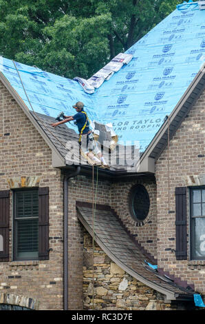 Roofing Contractors Replacing Damaged Roofs After a Hail Storm Stock Photo