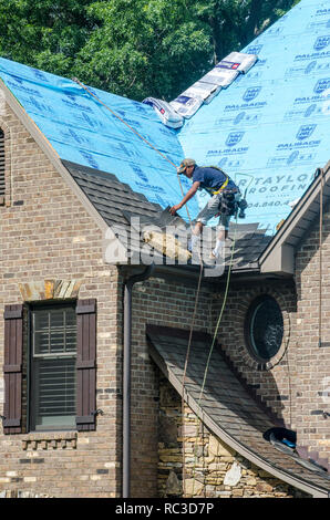 Roofing Contractors Replacing Damaged Roofs After a Hail Storm Stock Photo