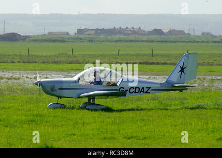 AEROTECHNIK EV-97 EUROSTAR G-CDAZ amateur built microlight landing at Leysdown on a wet grass runway. Owned and built by Michael Ludlow Stock Photo