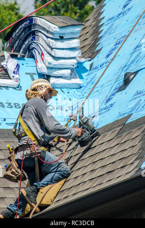 Roofing Contractors Replacing Damaged Roofs After a Hail Storm Stock Photo