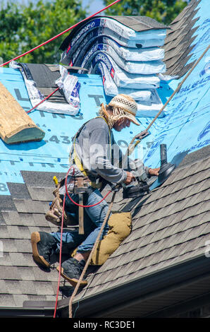 Roofing Contractors Replacing Damaged Roofs After a Hail Storm Stock Photo