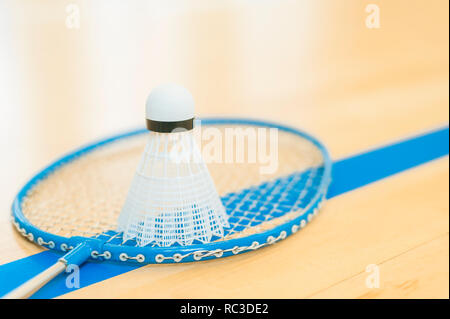 White badminton shuttlecock on a hall floor at badminton courts .Close up shuttlecocks on racket badminton at badminton courts. Stock Photo