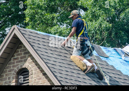 Roofing Contractors Replacing Damaged Roofs After a Hail Storm Stock Photo