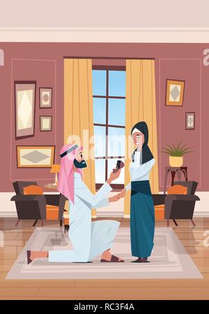 arab man kneeling holding engagement ring proposing arabic woman marry him couple in love wedding marriage offer happy valentines day concept living room interior vertical Stock Vector