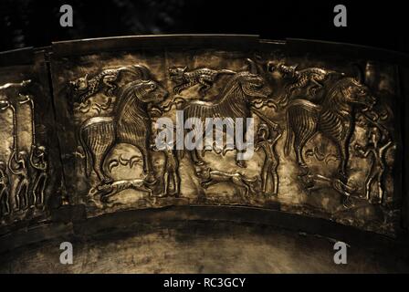 The Gundestrup cauldron. Decorated silver vessel, thought to date between 200 BC and 300 AD, placing it within the late La Te ne period or early Roman Iron Age. Gundestrup in the Aars parish of Himmerland, Denmark.  Ritual sacrifice of three bulls by three men with a sword. Each bull has a dog at its feet and another above its back. National Museum of Denmark. Stock Photo