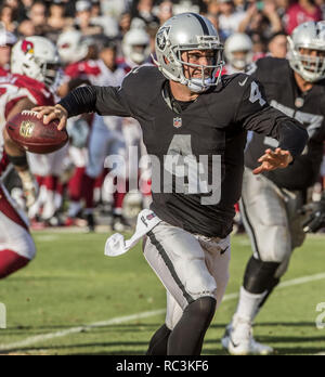 Oakland, California, USA. 30th Aug, 2015. Oakland Raiders quarterback Derek Carr (4) rolls out to make pass on Sunday, August 30, 2015 at O.co Coliseum in Oakland, CA. The Cardinals defeated the Raiders 30-23 in a preseason game. Credit: Al Golub/ZUMA Wire/Alamy Live News Stock Photo