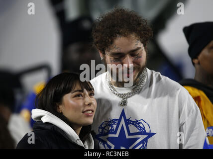 Rapper Post Malone and a woman watch the Los Angeles Rams