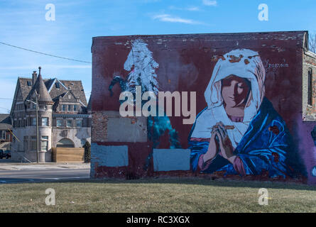 Detroit, USA. 13th Jan, 2019. The huge picture of a praying Madonna characterizes the weathered facade of a house. Graffiti and street art are among the most important art forms in the metropolis. Credit: Boris Roessler/dpa/Alamy Live News Stock Photo