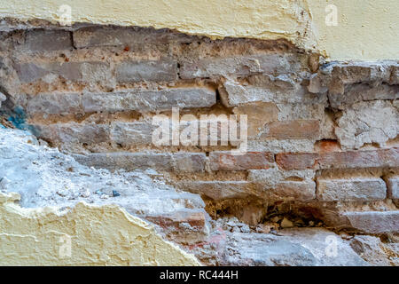 Falling facade.Brick wall. Facade in need of maintenance. Building maintenance. Stock Photo