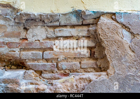 Falling facade.Brick wall. Facade in need of maintenance. Building maintenance. Stock Photo