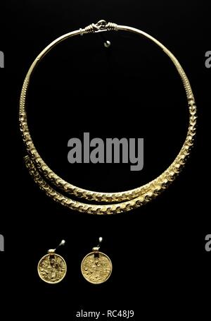 Gudme. Home of the gods. 3rd-7th century. Gold jewerly. Golden neck ring with locks and bracteates from Hesselager. National Museum of Denmark. Stock Photo