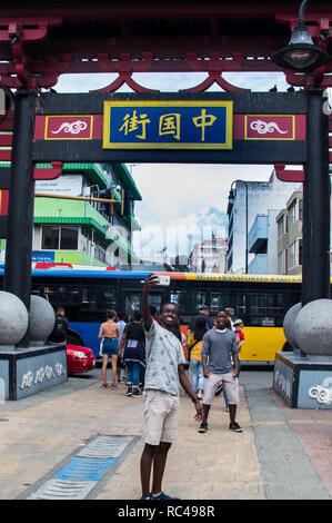 A photo of two school students taking a selfie at the entrance of China town in San jose, Costa Rica Stock Photo