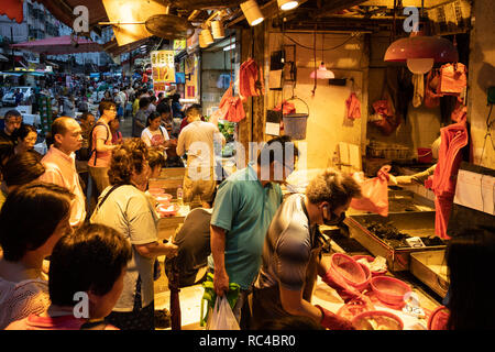 Hong Kong, China - October 13 2018: People buying seafood at the the Chun Yeung Street market in North Point in Hong Kong island. This is a traditiona Stock Photo