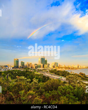 Perth Australia. The city glowing in the late afternoon sun with a rainbow overhead as viewed from the lookout in  Kings Park, Perth,Western Australia Stock Photo