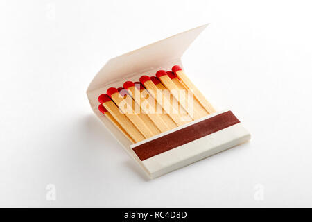 Open matchbox book, full of matches with red heads. Isolated on white background with shadow Stock Photo