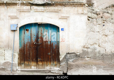 Old city house white wall and wooden aged blue door Stock Photo