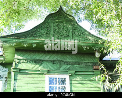 Plinths of windows of wooden houses. Ancient style of decoration of window frames. Stock Photo