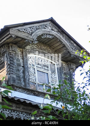 Plinths of windows of wooden houses. Ancient style of decoration of window frames. Stock Photo